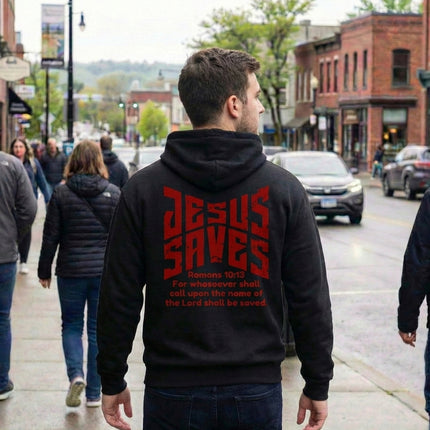 Person wearing a black hoodie with 'Jesus Saves' text on the back in an urban setting.
