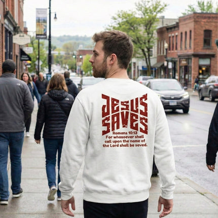 Person wearing a white sweatshirt with 'Jesus Saves' text on a city street.