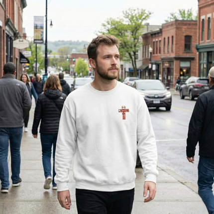 Man walking on a sidewalk wearing a white sweatshirt with a red logo, surrounded by urban street scene.